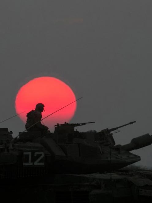 An Israeli tank manoeuvres outside the northern Gaza Strip. REUTERS/Baz Ratner
