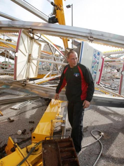 An Ottaway Amusement employee walks around the Century Wheel in Wichita, Kansas. The Ferris wheel...