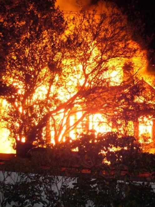 An unoccupied house in Whitby St, Dunedin, ablaze yesterday morning. Photo by Val Reggett.