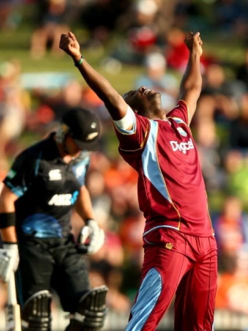 Andre Russell of the West Indies celebrates his wicket of Corey Anderson of New Zealand.  (Photo...