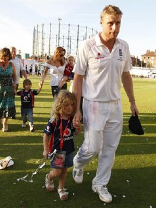 Andrew Flintoff walks off the pitch with his daughter following the after match celebration as...