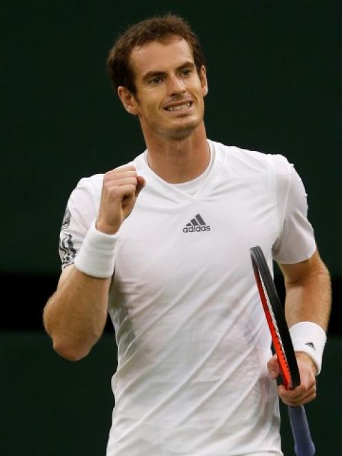 Andy Murray of Britain reacts after defeating Tommy Robredo of Spain in their men's singles match...