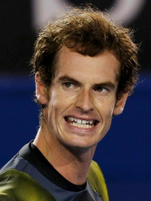 Andy Murray of Britain reacts during his men's singles semi-final match against Roger Federer of...