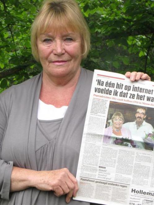 Anna Skeet, of Alexandra, holds a Dutch newspaper containing a photo of her and new-found half...