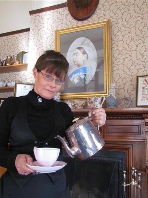 Annie Baxter pours a cup of tea after announcing that Annie's Victorian Tearooms  will  close...