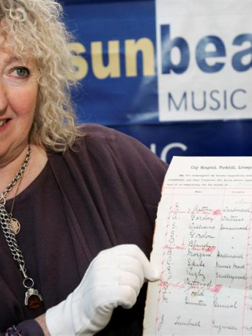 Annie Mawson, of Sunbeams Music Trust charity, poses with a page from a 1911 Corporation of...