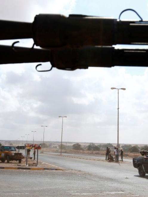 Anti-Gaddafi fighters man a checkpoint approximately 2km from the centre of Sirte. Photo: REUTERS...
