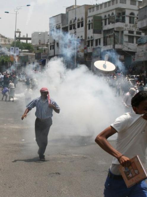 Anti-government protesters demanding the ouster of Yemen's President Ali Abdullah Saleh flee...