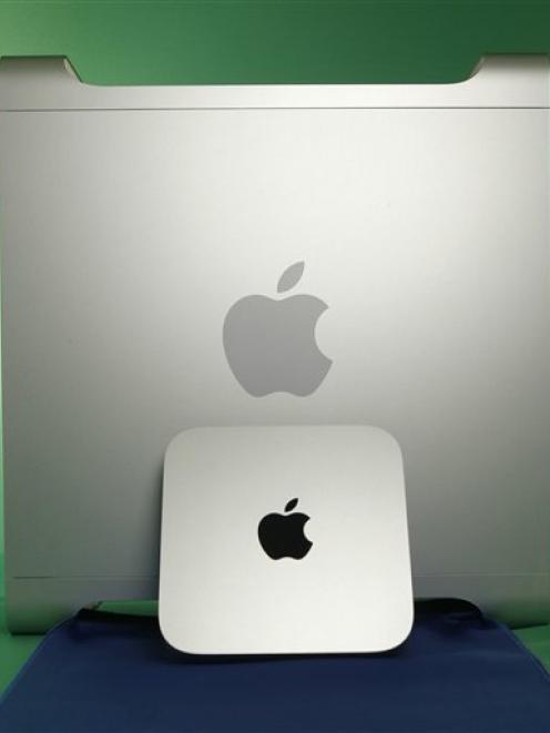 Apple's new Mac Mini, it's smallest and cheapest computer, is shown next full-size Mac Pro...