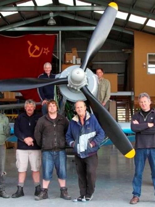 Appreciating restoration work are (top, from left) Yak 3 part-owner Graeme Frew, of Auckland, JEM...