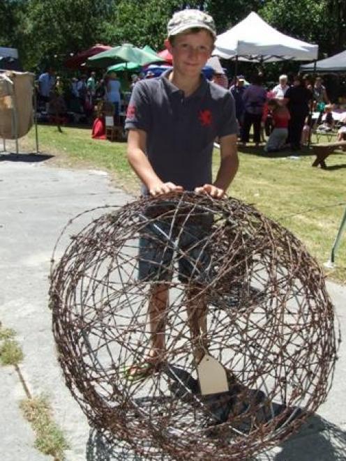 Archie Calder (11), of Becks, admires one of his father Robbie's garden  spheres made out of...