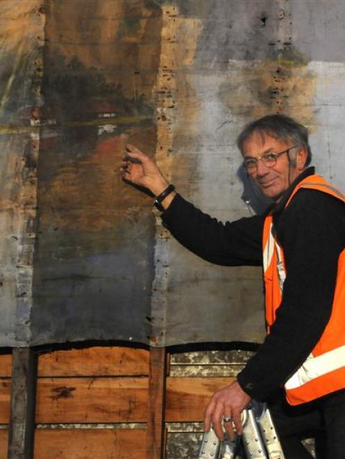 Architectural conservator Guy Williams looks at the finer detail of a 100-year-old, Japanese...