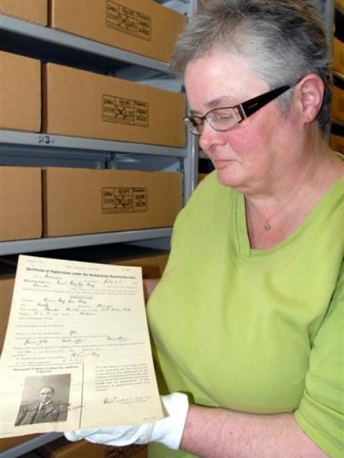 Archives New Zealand archivist Vivienne Cuff with a certificate of registration and photograph of...