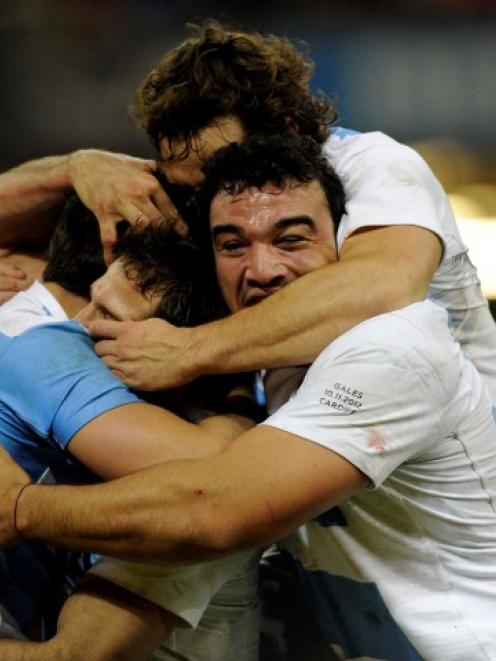 Argentina's Juan Imhoff (L) celebrates with his teammates after scoring a try against Wales...
