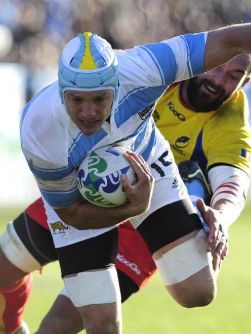Argentina's Juan Manuel Leguizamon sights the tryline in the tackle of Valentin Ursache, of...
