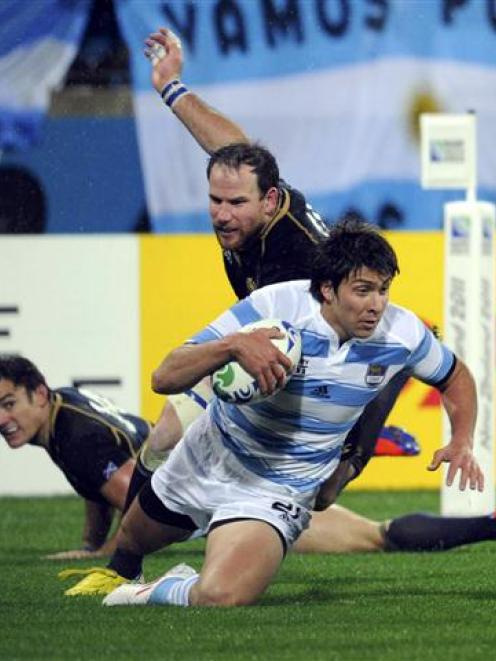 Argentina's Lucas Gonzalez Amorosino scores a brilliant try  against Scotland. REUTERS/Anthony...