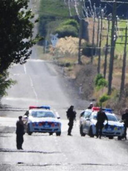 Armed police cordon off Narrowdale Rd, Milburn, while the Armed Offenders Squad detains a man who...