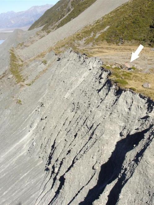 The moraine wall of the receding Tasman Glacier, with the Ball Shelter perched near the moraine...