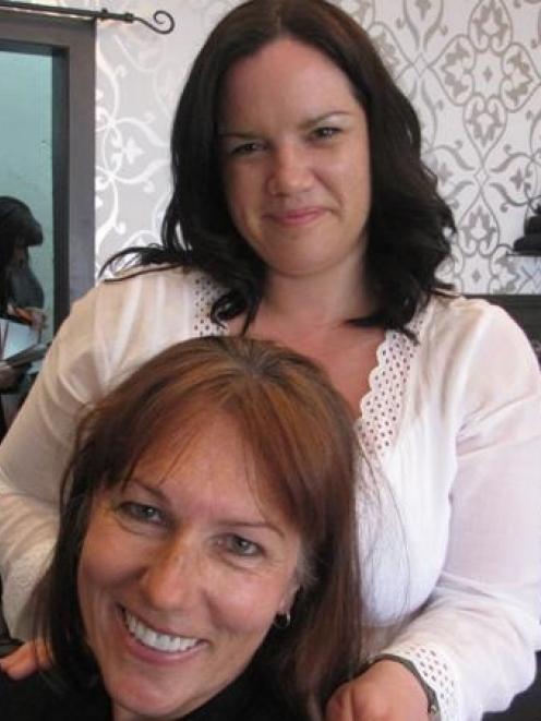 Arrowtown Hair Company owner Nikki Nash prepares to give Queenstown police Sergeant Kate Pirovano...