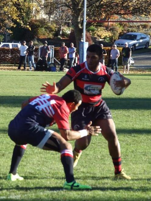 Arrowtown player Joji Ravula (with the ball) goes into battle with Cromwell. Photo by Christina...