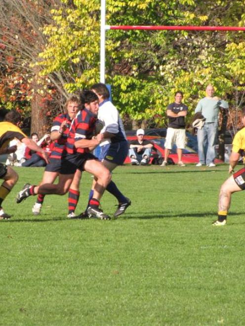 Arrowtown's Ben Chisholm on the charge with captain Aidan Winter in support against Upper Clutha...