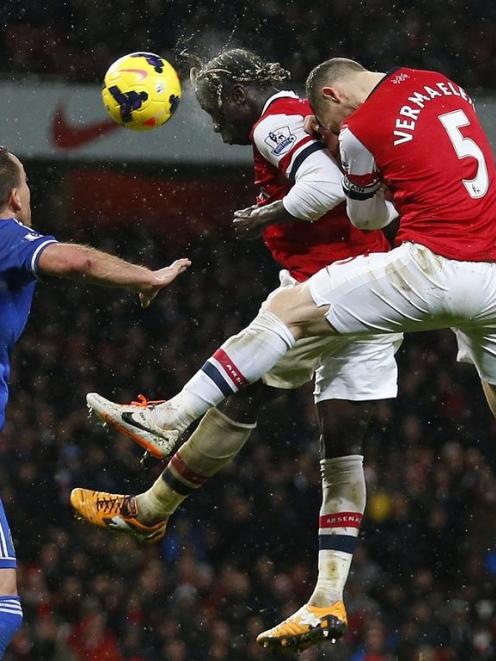 Arsenal's Bacary Sagna and Thomas Vermaelen jump to head the bal.  REUTERS/Andrew Winning