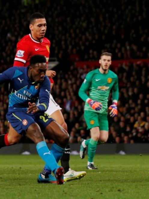 Arsenal's Danny Welbeck shoots to score against Manchester United. Action Images via Reuters /...
