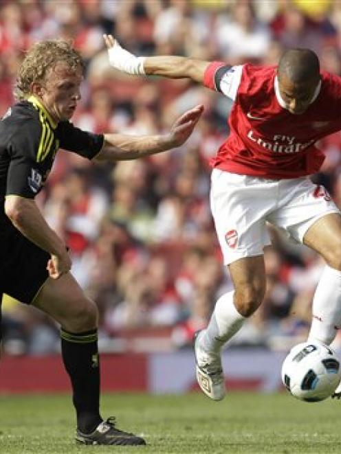Arsenal's Gael Clichy, right, competes with Liverpool's Dirk Kuyt during their English Premier...