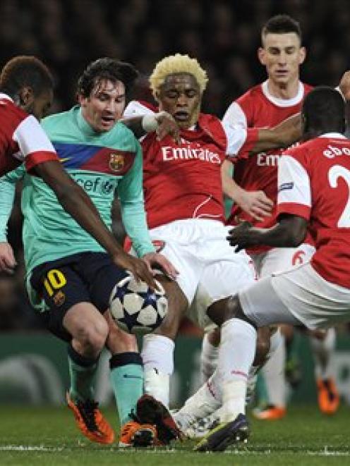 Arsenal's Johan Djourou, at left, with teammates Alex Song, centre and Emmanuel Eboue, at right,...