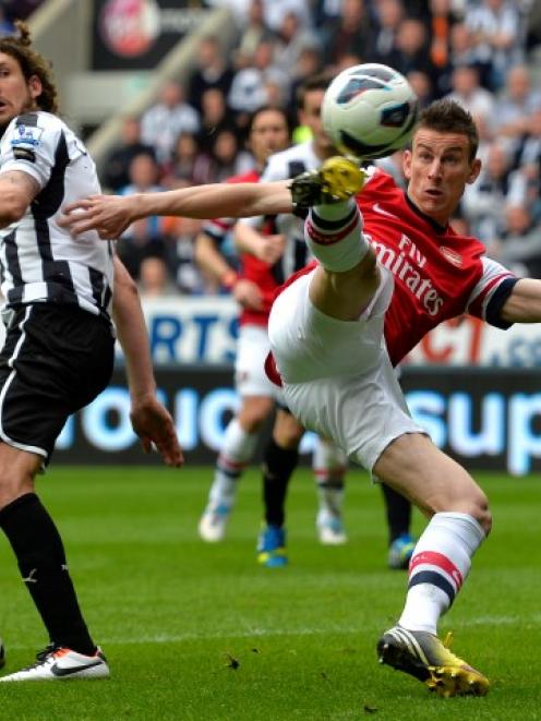 Arsenal's Lourent Koscielny (R) shoots to score against Newcastle United during their English...