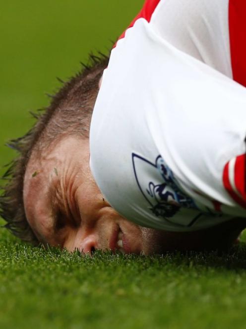 Arsenal's Mathieu Debuchy reacts after being fouled during their English Premier League soccer...