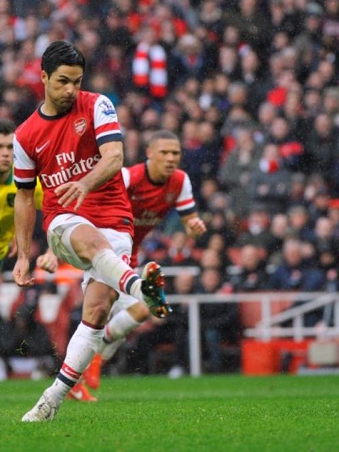 Arsenal's Mikel Arteta shoots to score against Norwich City during their English Premier League...