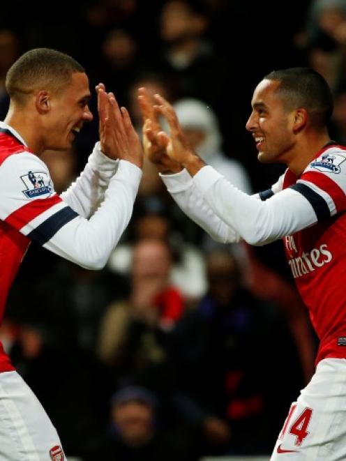 Arsenal's Theo Walcott (R) celebrates his third goal against Newcastle United with Kieran Gibbs...
