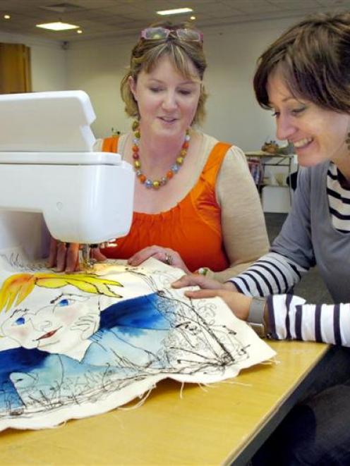 Artist Louise Gardiner (right), of the United Kingdom, shows Janine Smith, of Oamaru, the...