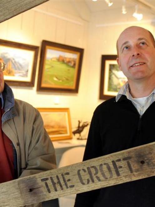 Artist Peter Beadle and his son Simon inspect a picture frame in their recently opened Arrowtown...
