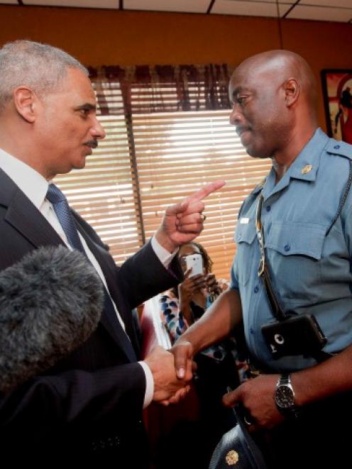 Attorney General Eric Holder talks with Capt. Ron Johnson of the Missouri State Highway Patrol at...