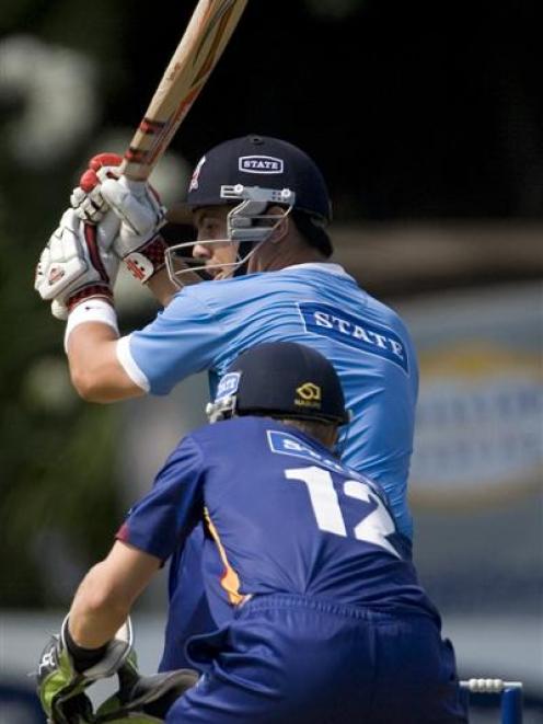 Auckland batsman Anaru Kitchen plays a shot in front of Otago wicketkeeper Derek de Boorder...