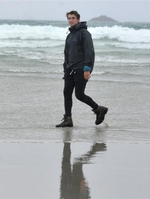 Auckland man Brando Yelavich walks on St Clair Beach in Dunedin yesterday as part of his  journey...