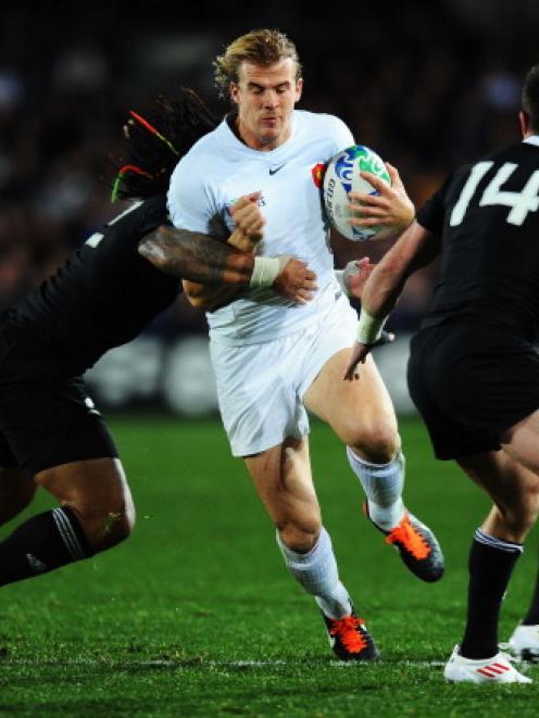 Aurelien Rougerie tries to bust through the defence of Ma'a Nonu (L) and Cory Jane during the...