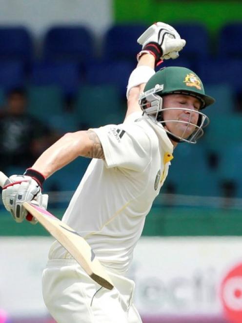 Australia captain Michael Clarke celebrates after scoring a century during the final day of their...