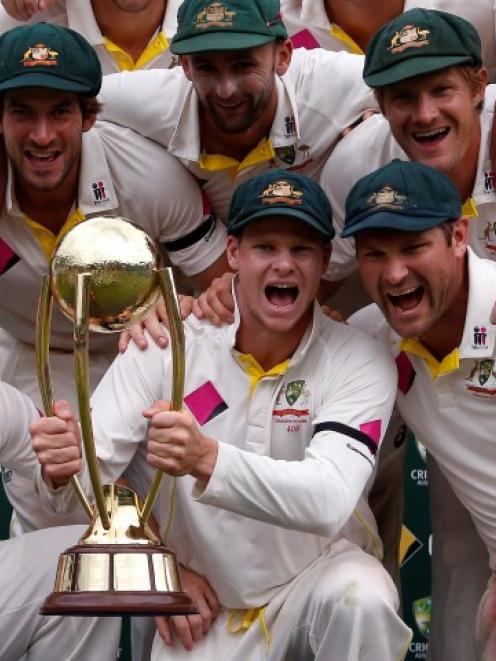 Australia captain Steven Smith (C) holds the Border-Gavaskar trophy after his team won the series...