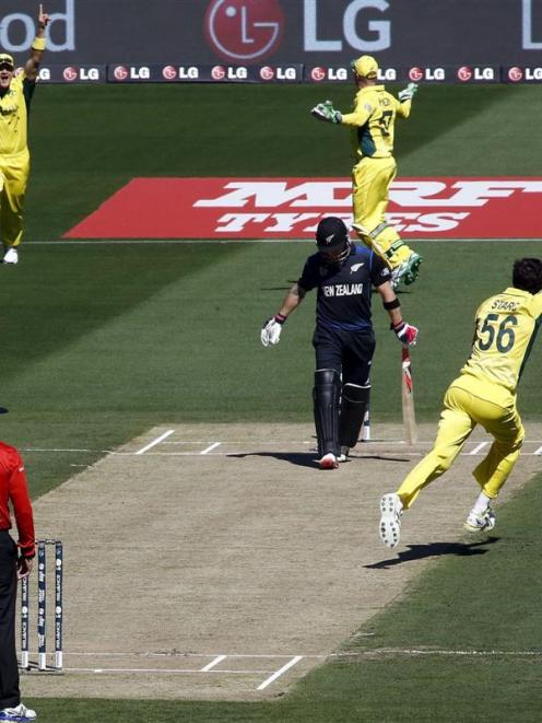 Australia's Mitchell Starc (right) celebrates after bowling New Zealand captain Brendon McCullum...