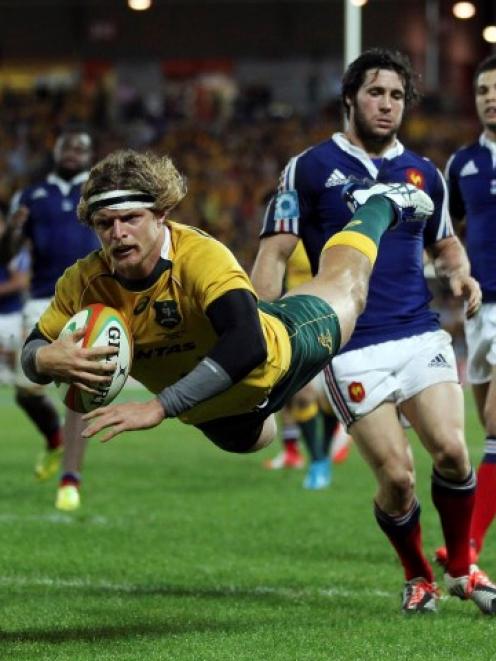 Australia's Nick Cummins dives to score a try against France. REUTERS/Jason O'Brien
