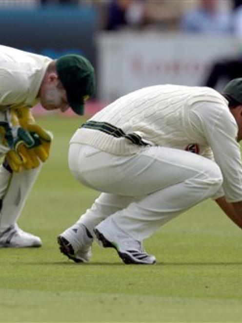 Australia's Ricky Ponting, right, reacts after failing to hold on to an edged ball from England's...