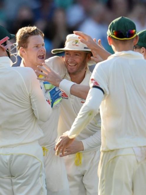 Australia's Steve Smith (2nd L)is congratulated after dismissing England's Alastair Cook. Reuters...