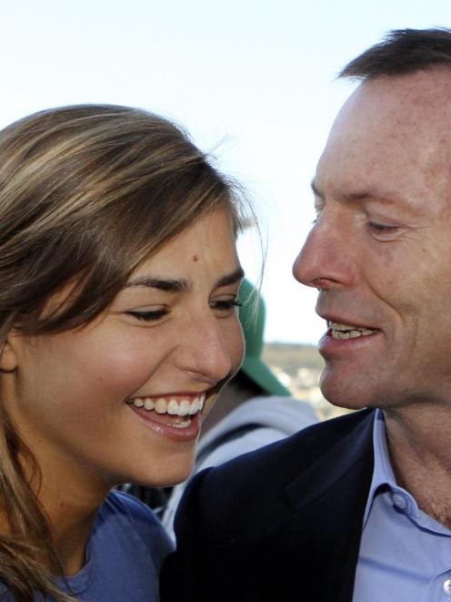 Australia's then-opposition Leader Tony Abbott talks to his daughter Frances during a visit to...