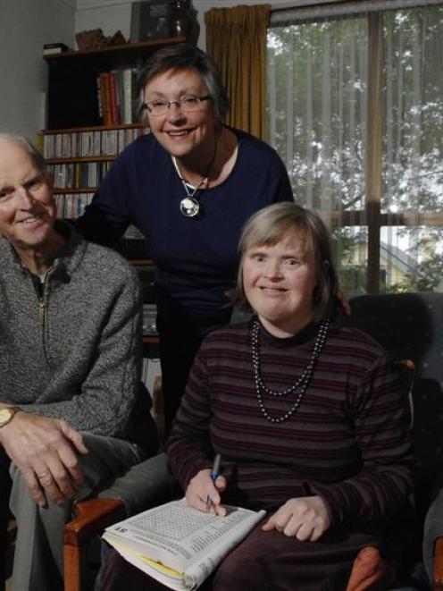 Author Huberta Hellendoorn (centre) with her husband Bart, help their daughter Miriam, who has...