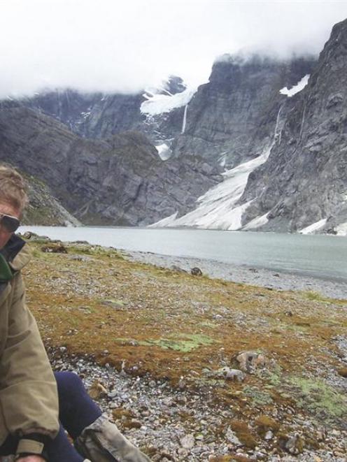 Author John Breen sits in front of the terminal lake of the Volta and Therma glaciers. The...