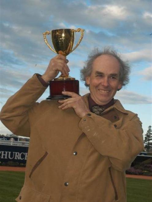 Awapuni trainer Mark Oulaghan proudly elevates the Winter Cup after Shamrock Star's win in the...