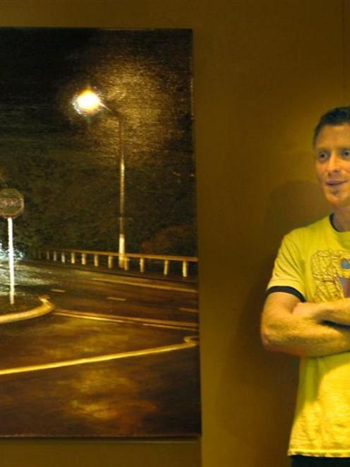 Award-winning artist Sam Foley stands next to his Opoho Intersection No. 1, a kinetic painting...